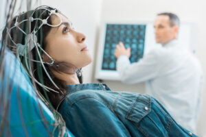 Charming-young-woman-undergoing-electroencephalography-832991434_1258x838